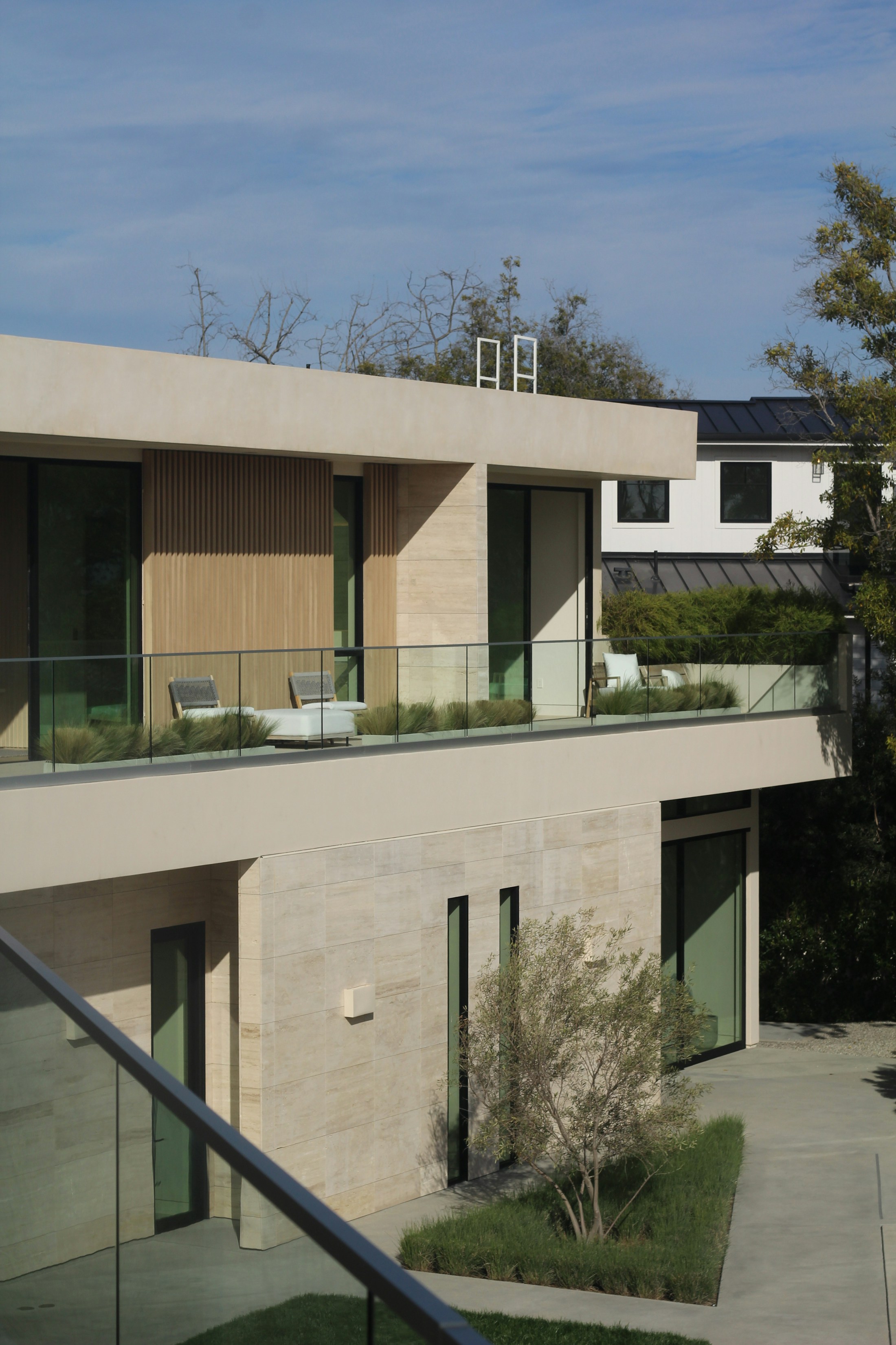 Contemporary California residence with pale stone, glass, and wood details